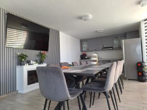 a dining room with a table and chairs and a kitchen at LuxuryGiftloc in Bucharest