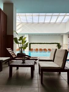 a living room with a couch and a swimming pool at Cevahir Sky View in Skopje +15 photos
