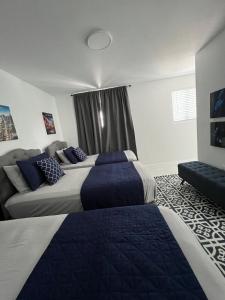 a hotel room with two beds and a couch at Magic City IN THE HEART OF MIAMI in Miami