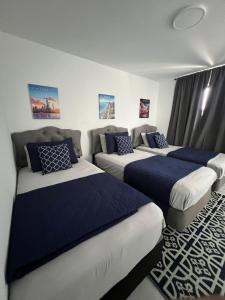 a room with three beds and a couch at Magic City IN THE HEART OF MIAMI in Miami +21 photos