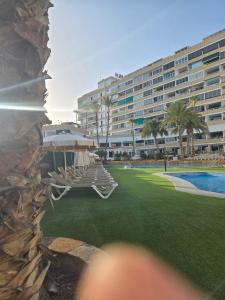 a boat sitting on a lawn in front of a building at Loft Dreams Koka in San Bartolomé de Tirajana