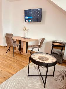 a dining room with a table and chairs and a table at Liesingtal Deluxe Terrace Family Suite in Vorderlainsach +8 photos