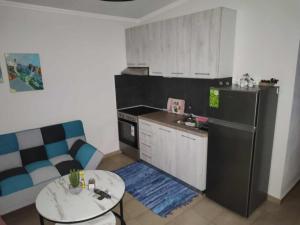 a kitchen with a black refrigerator and a table at Ismini's Luxury Villas in Mirodháton