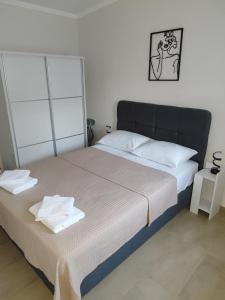 a bedroom with a bed with two towels on it at Ismini's Luxury Villas in Mirodháton