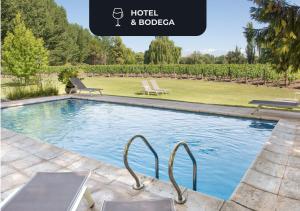 a large swimming pool with two chairs and a garden at Postales by DOT Boutique in Colonia Las Rosas