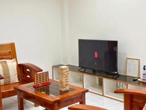 a living room with a tv and a table at Blue House El Nido in El Nido