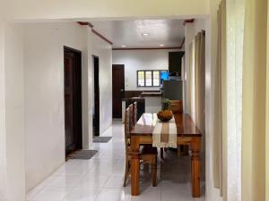 a kitchen and dining room with a table and chairs at Blue House El Nido in El Nido