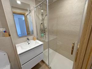 a white bathroom with a sink and a shower at Sol y Mediterráneo in Oropesa del Mar +11 photos
