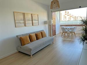 a living room with a couch and a table at Sol y Mediterráneo in Oropesa del Mar