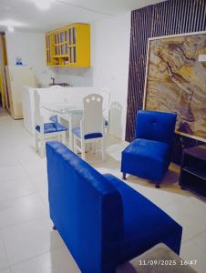 a dining room with blue chairs and a table at Villa Liliana in Armenia +1 photo