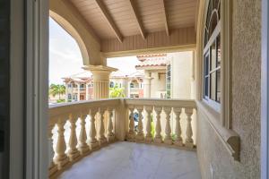 a balcony with white railings and a window at Summer Shades Villa at Legacy in Montego Bay