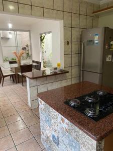 a kitchen with a stove and a counter top at Casa para temporada in Guarapari