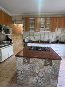 a kitchen with a island in the middle of it at Casa para temporada in Guarapari