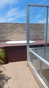 a view of a balcony from a glass window at Casa para temporada in Guarapari +2 photos