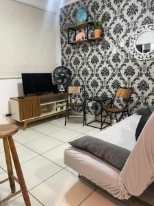 a living room with a couch and a tv at salaliving 405 in São Vicente +10 photos