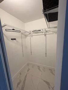 a walk in shower in a bathroom with white walls at Family Willy Michel in Opa-locka +9 photos