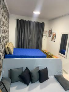 a bedroom with a bed with blue sheets and pillows at salaliving 405 in São Vicente
