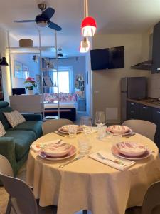 a table with plates and glasses on it in a living room at Casa Danesi in Monteleone dʼOrvieto +19 photos