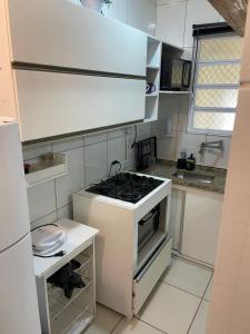 a kitchen with a stove top oven in a kitchen at salaliving 405 in São Vicente +10 photos