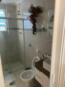 a bathroom with a shower and a toilet and a sink at salaliving 405 in São Vicente