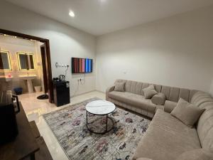 a living room with a couch and a table at أستديو كلاود السحاب in Al Baha +10 photos