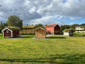 a group of barns and houses in a field at Heiberg's apartment in Bodø +22 photos