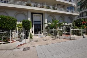 a building with a gate in front of it at Appartement 53 Promenade des Anglais in Nice