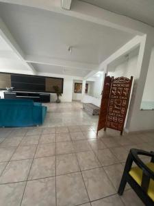 a large living room with a couch and a piano at Casa para temporada in Guarapari