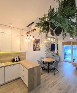 a kitchen and dining room with a table and chairs at Perfect View II - idealny widok na Marinę in Iława