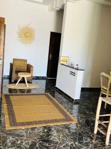 a living room with two chairs and a table at Spacious and comfortable villa in Marrakesh