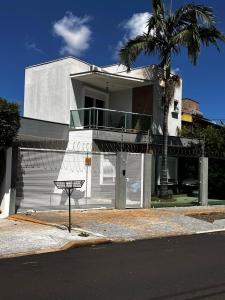 a white house with a basketball hoop in front of it at Casa de alto padrão em Maringá Zona 4 in Maringá