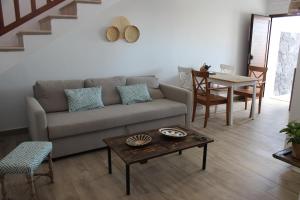 a living room with a couch and a table at Casa Antonio-Tinajo in Tinajo +9 photos