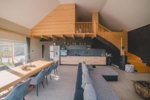 a dining room with a long table and a kitchen at Beg Residence in Rogaška Slatina