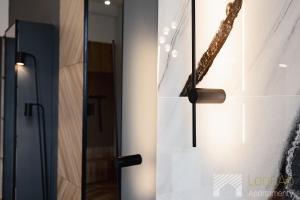 a glass door with a bronze door knocker on it at Jaracza Exclusive by LookAp - darmowy parking w centrum!! in Łódź +12 photos