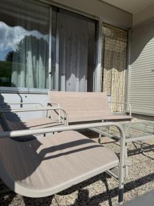 a picnic table and bench on a porch at AlpinVista- Le Maddalene in Cavareno