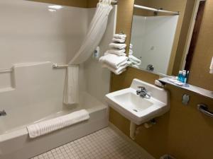 a bathroom with a sink and a bathtub and a sink at Comfort Inn Pikeville in Pikeville