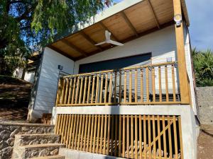 a house with a wooden gate and a porch at La Kazadoo in Piton Saint-Leu