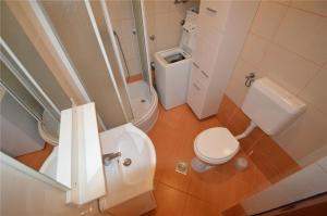 a bathroom with a white toilet and a sink at Apartment Nevena in Mali Lošinj