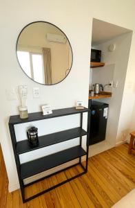 a black and white dresser with a mirror on the wall at Rambla Bliss Suites con Vista al Mar in Montevideo