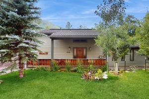 a house with a fence and a yard at Booth Falls Chalet in Mid Vail