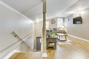 a living room with a table and a clock on the wall at Walk to Canal St Trolley! Mid-City NOLA Retreat in New Orleans