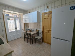 a kitchen with a white refrigerator and a table and chairs at Tierra de Pinares 2 in Vinuesa