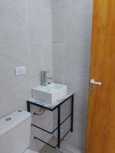 a bathroom with a sink and a toilet at Tiny House Potrero Cba in Potrero de Garay +9 photos