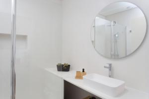 a bathroom with a white sink and a mirror at BJ Apartments Funchal in Funchal +79 photos