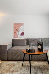 a living room with a couch and a table at SB Nest Apartment in Braşov