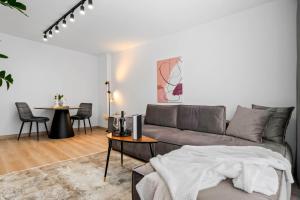 a living room with a couch and a table at SB Nest Apartment in Braşov