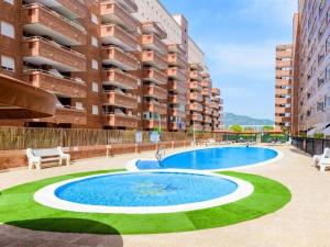 a large swimming pool in front of a building at Sol y Mediterráneo in Oropesa del Mar