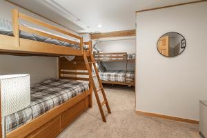 a bedroom with two bunk beds and a mirror at Mountain Calling in Grand Lake