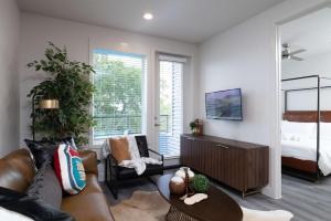 a living room with a couch and a table at Trinity River - Skyline Views - King bed in Fort Worth