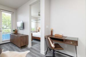 a bedroom with a desk and a bed and a mirror at Trinity River - Skyline Views - King bed in Fort Worth +24 photos